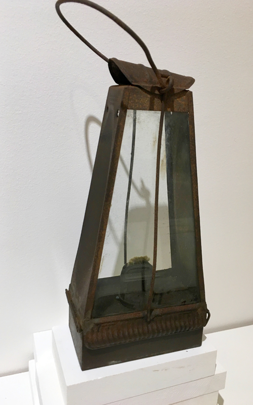 <h3>Rushlight Holder</h3>
<br>
<p><i>Maker unknown</i>
<p><strong>Eighteenth/early nineteenth century</strong></p>
<br>
<br>
<p>Rushlights were one of the main forms of illumination in poor households for centuries.  Rushes would be collected in the summer, the outer layers peeled off (except for one narrow strip to keep the shape), and then left to dry. They were finally dipped in kitchen fat that would have been saved for this purpose. The rush would be held in a nip – like pliers or tongs. When the rush burned, it not only gave off a weak light, it created an unpleasant smell, and left grease everywhere. A rush holder like this was probably made by the local blacksmith.</p>